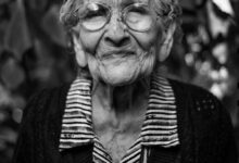 grayscale photography of woman standing