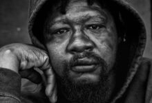 grayscale photo of a man wearing hoodie